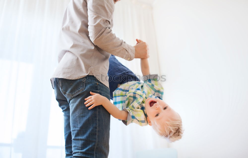 Similar – Image, Stock Photo A baby girl studies something on haunches, while her older brother watches her from upstairs sitting on the steps