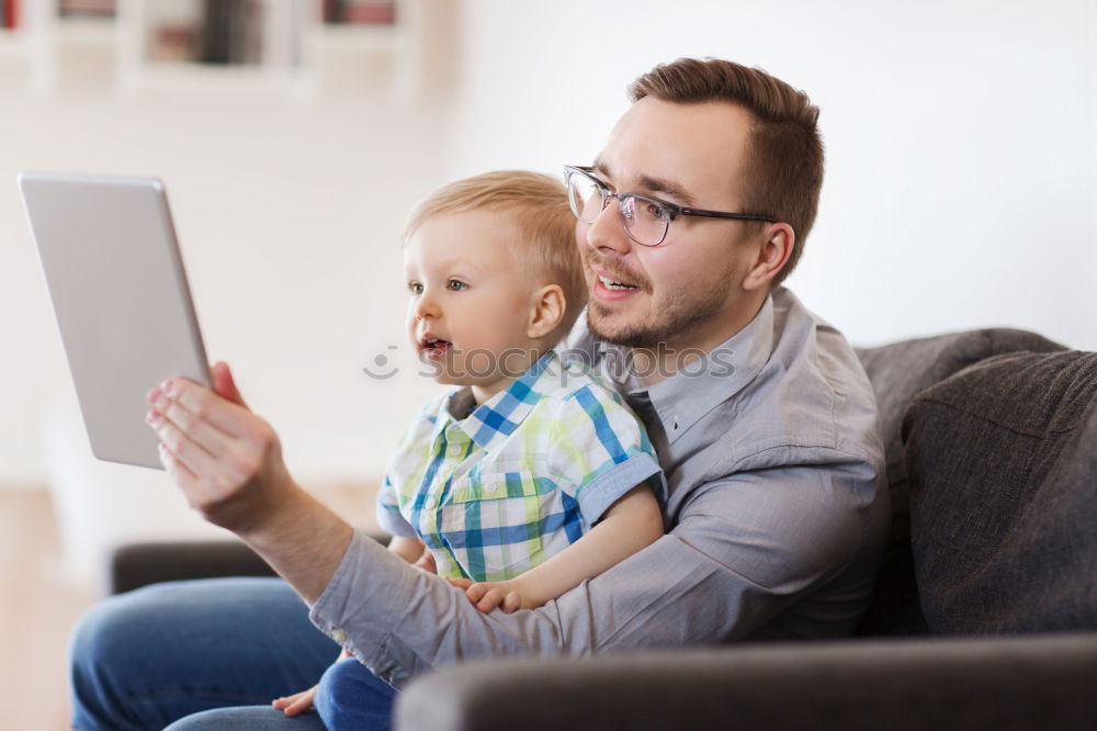 Similar – Mother reading a book to her baby son