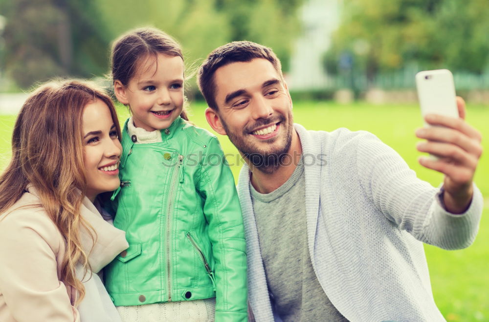 Similar – Young happy couple using smart phone sitting in the park