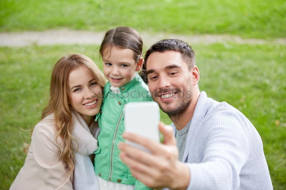 Similar – Young happy couple using smart phone sitting in the park