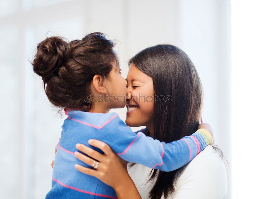 Similar – Image, Stock Photo Happy mother kissing her daughter enjoying a winter afternoon