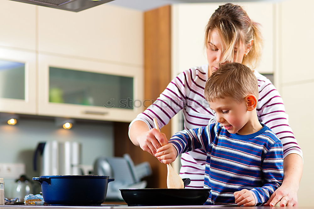 Similar – Image, Stock Photo Little sisters cooking with her mother in the kitchen.