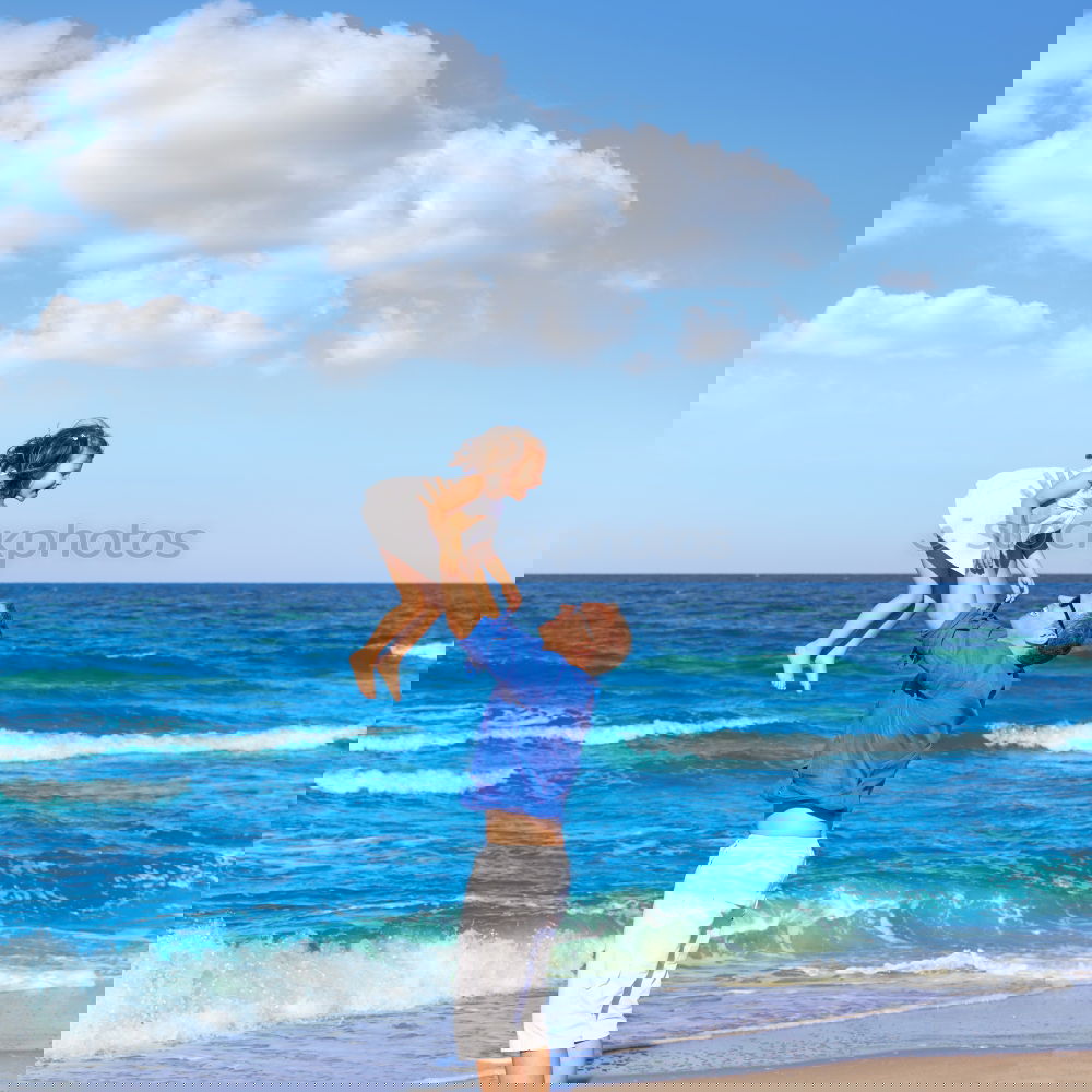 Similar – Image, Stock Photo Father and son playing on the beach at the day time. Concept of friendly family.