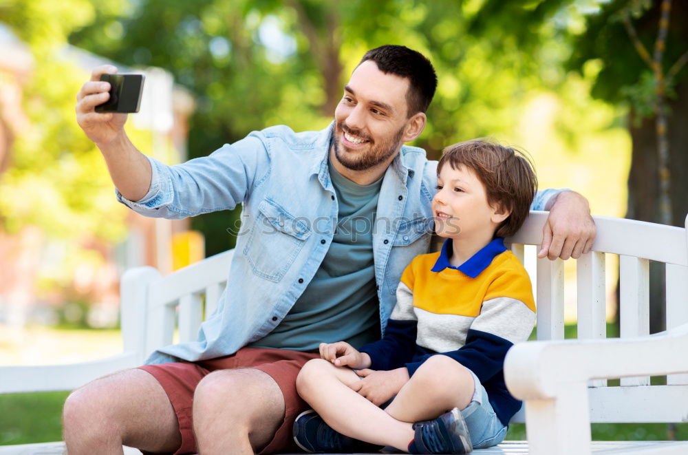 Similar – Young happy couple using smart phone sitting in the park