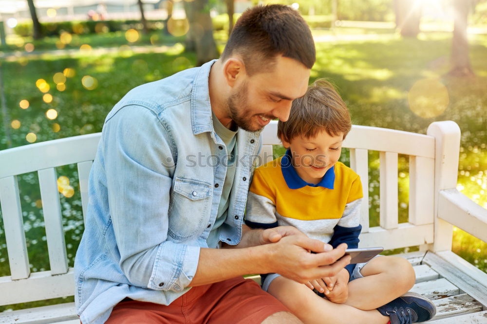 Similar – Young happy couple using smart phone sitting in the park