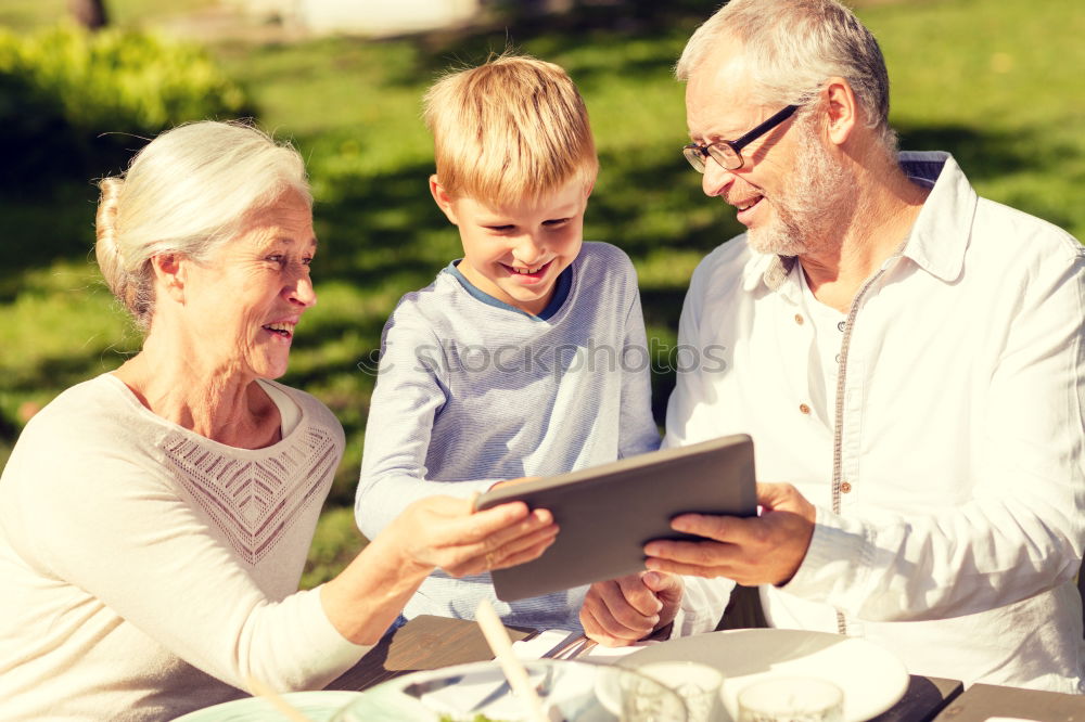 Similar – Image, Stock Photo Senior man and child reading a newspaper outdoors