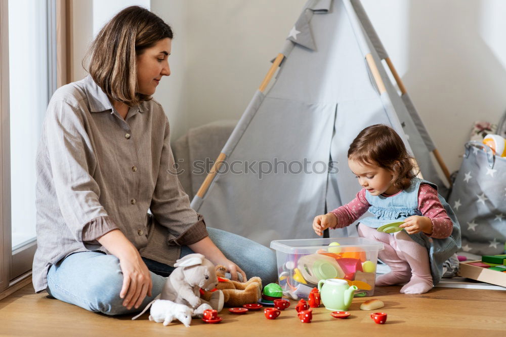 Similar – Girl and boy reading book sitting on bed