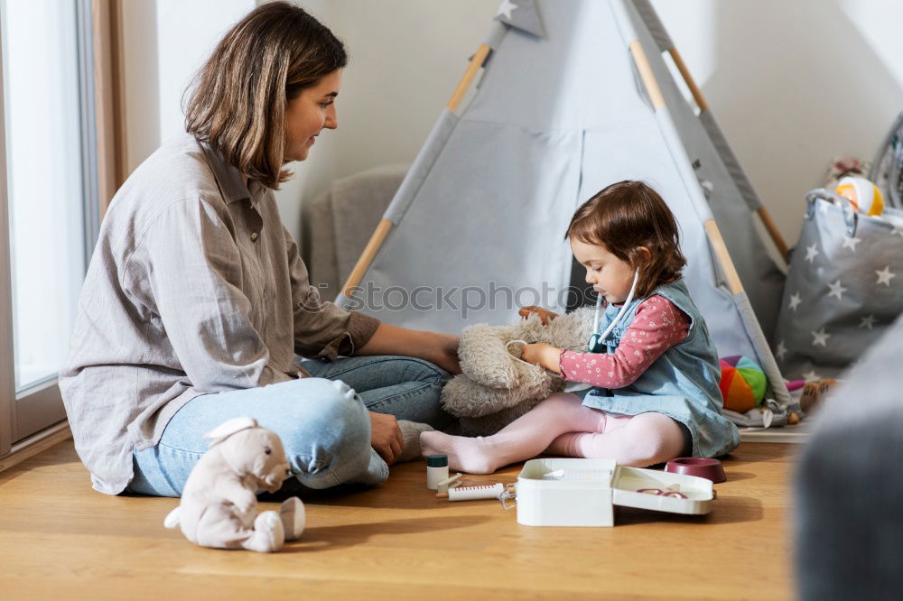 Similar – Girl and boy reading book sitting on bed