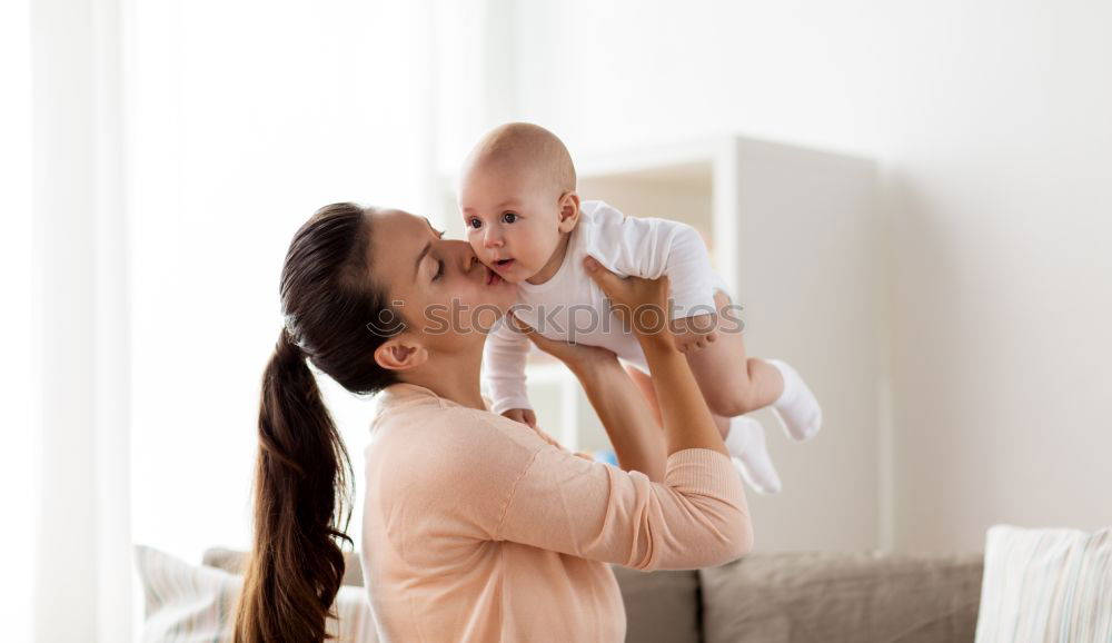 Similar – happy young mother and her baby boy lying on bed and smiling