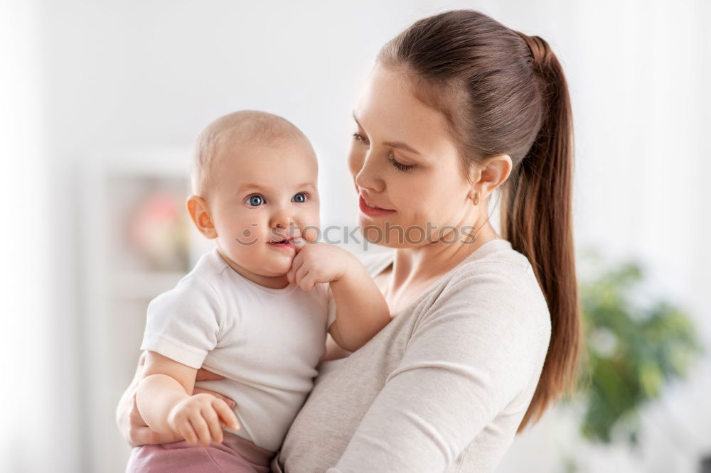 Similar – Image, Stock Photo Mother doing her little daughter’s hair. Family at home. Everyday life