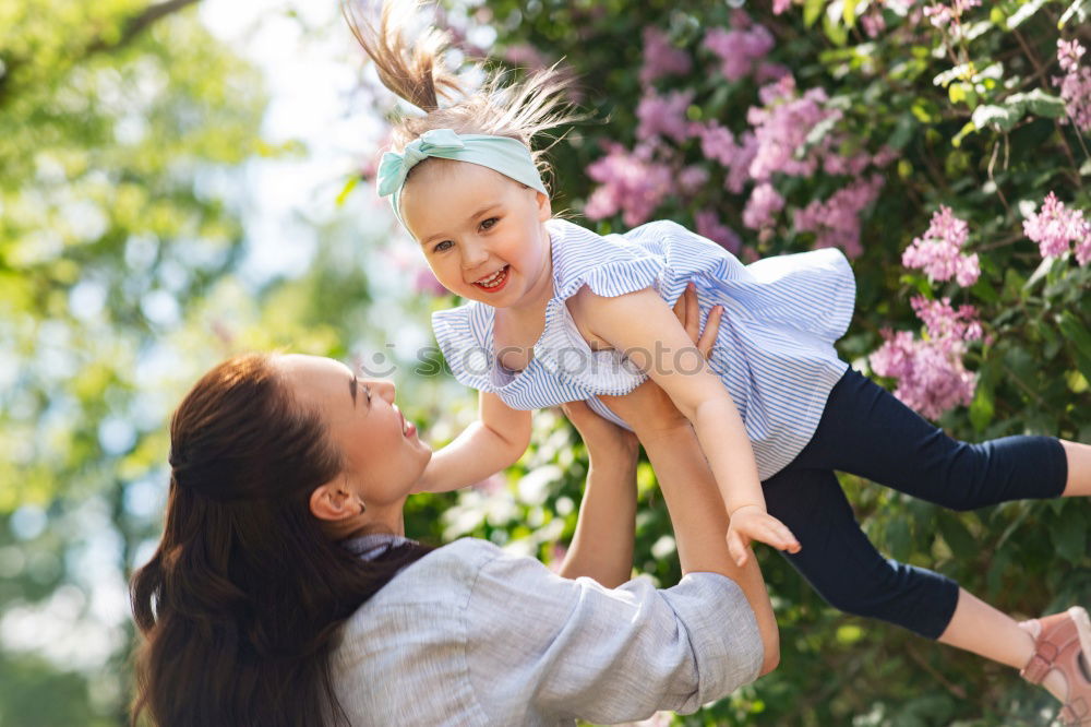 Similar – Baby girl standing on a bench hugging to woman