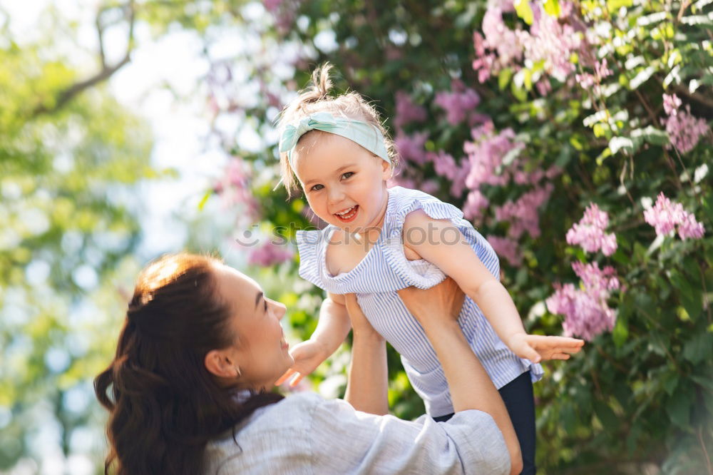 Similar – Baby girl standing on a bench hugging to woman