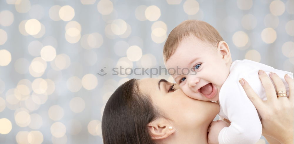 Similar – Woman playing with little happy baby on bed