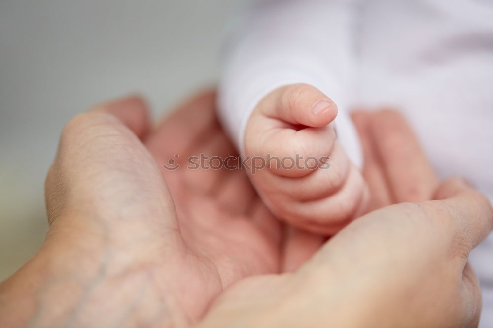 Similar – Baby girl sitting over legs of senior man outdoors