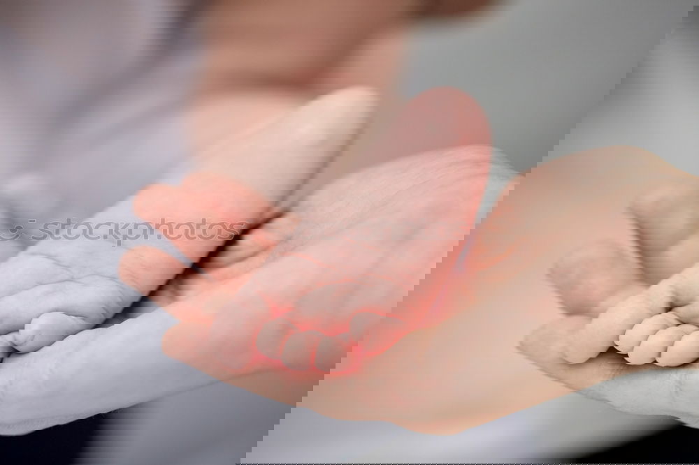 Similar – Image, Stock Photo Father hands holding feet of newborn lying over bed