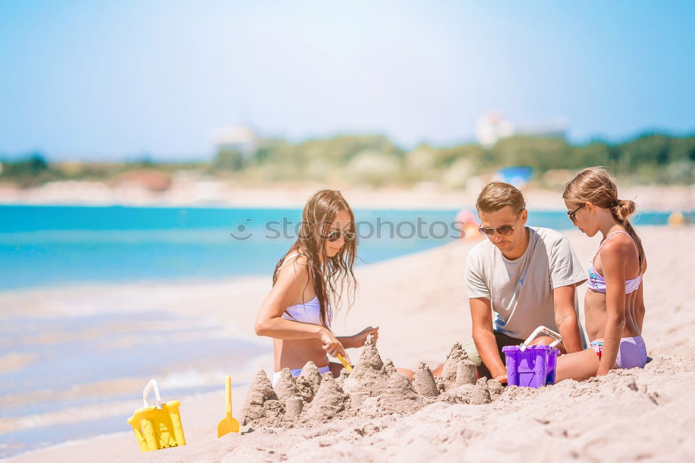 Similar – Image, Stock Photo Mother, father and little son on summer vacation at the seaside, They wearing snorkels and flippers while lying and playing on the beach