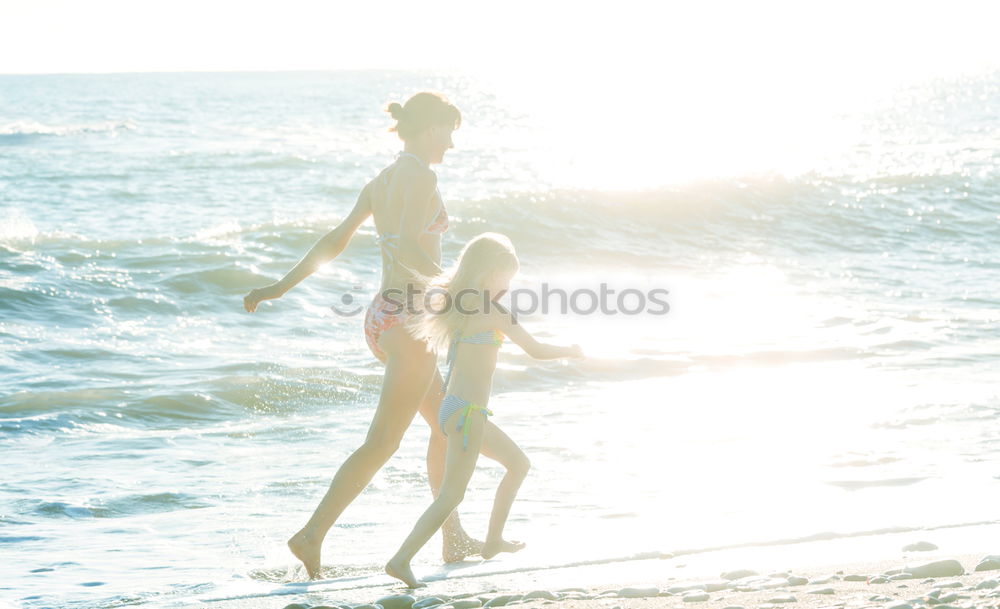 Similar – Image, Stock Photo Group of younf adult friends walking on the beach