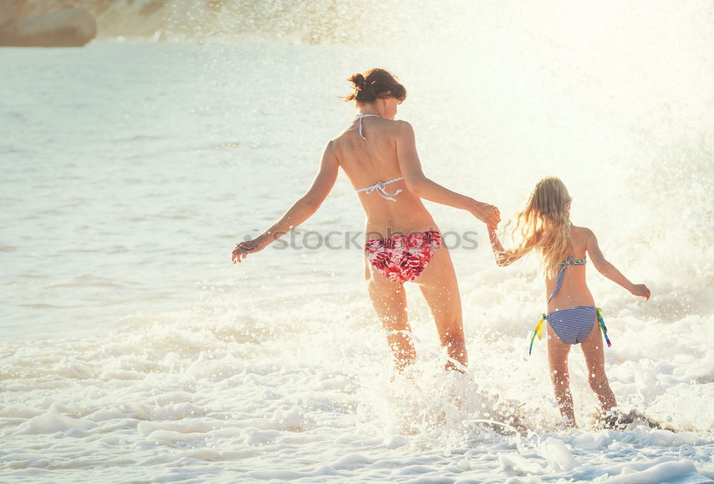 Image, Stock Photo caucasian mother and son playing with windmill at the beach