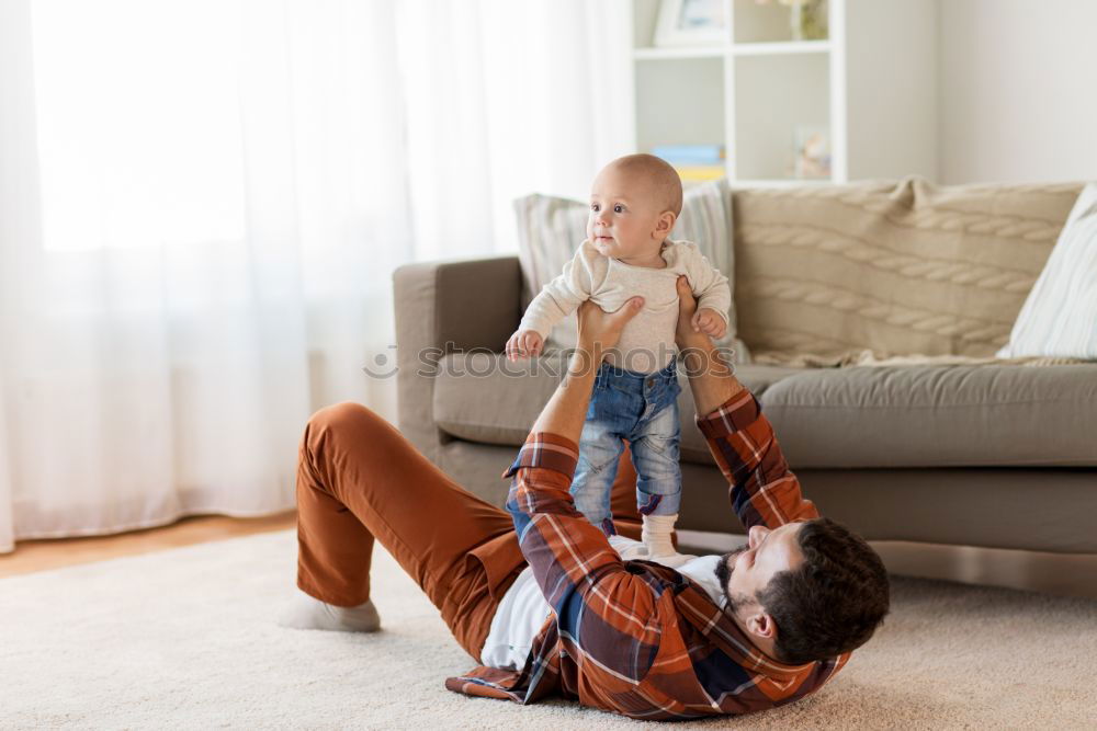 Similar – Image, Stock Photo A baby girl studies something on haunches, while her older brother watches her from upstairs sitting on the steps