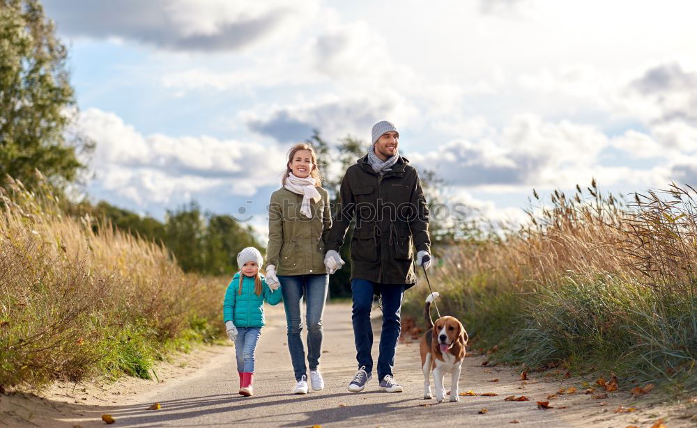 Similar – Happy family walking together holding hands in the forest