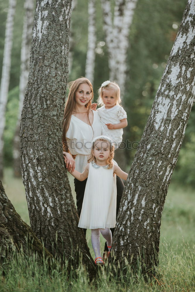 Similar – Grandmother with her grandchildren sitting in the field