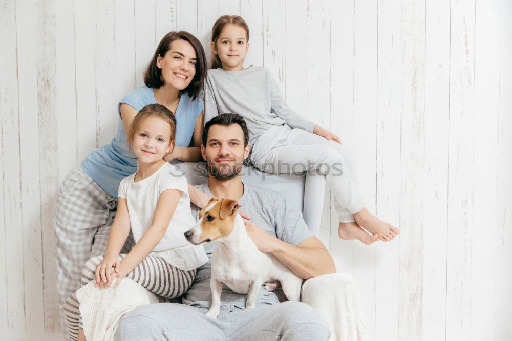 Similar – Mature couple relaxed at home in bed with their four little daughters and the Dog