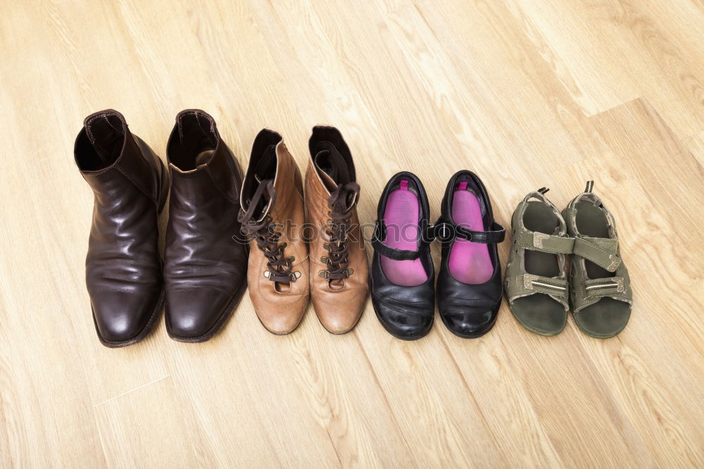 Similar – Row of wellies standing on a wooden porch while raining