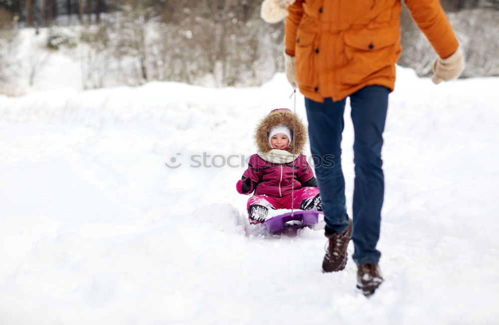 Similar – Teenage girl pulling sled with her little sister through forest