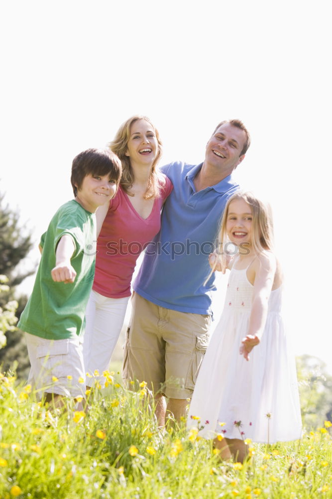 Similar – happy family of four hand in hand on the field