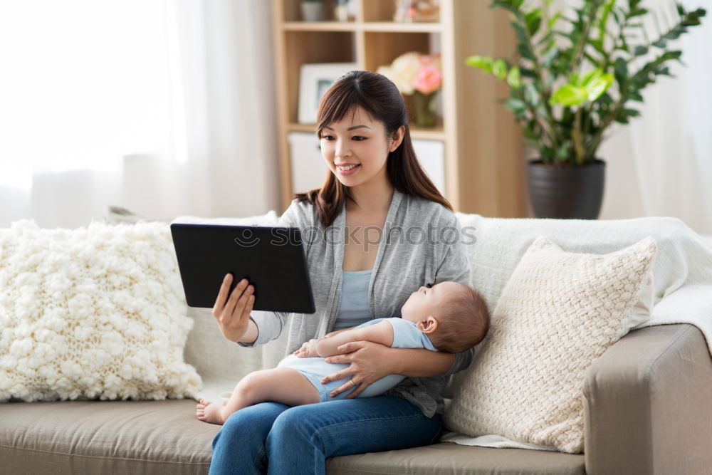 Similar – Mother breastfeed baby while playing with smartphone