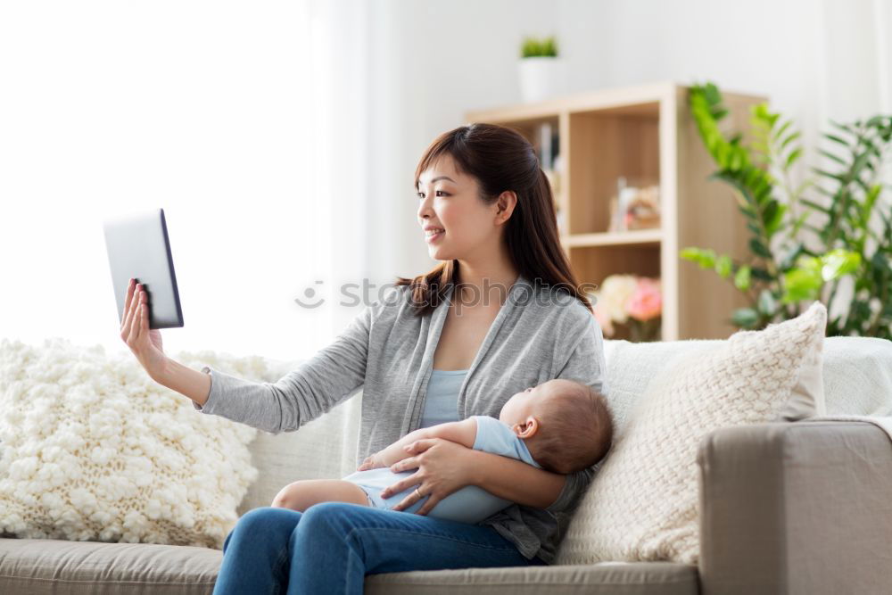 Similar – Mother breastfeed baby while playing with smartphone