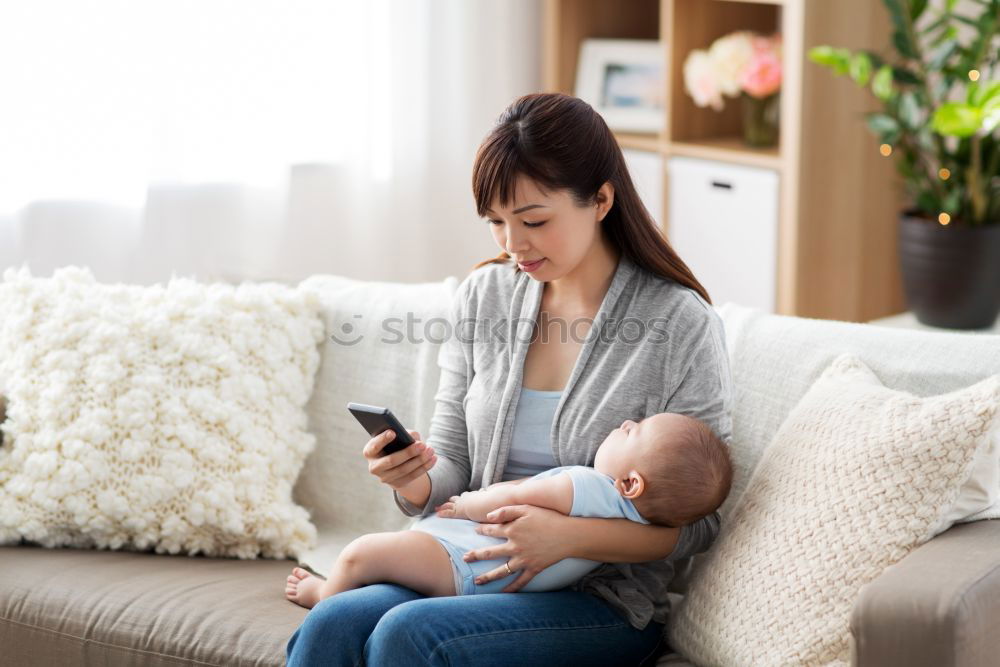 Similar – Mother breastfeed baby while playing with smartphone