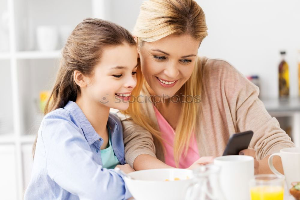 Similar – Image, Stock Photo Little girl cooking with her mother in the kitchen.