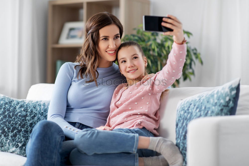 happy mother and toddler son using tablet