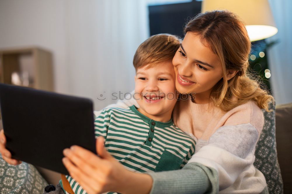 Similar – happy mother and toddler son using tablet