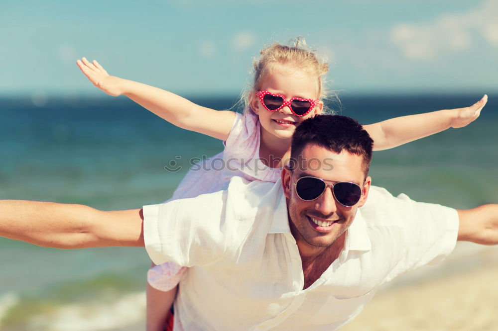 Similar – Father and daughter with balloons playing on the beach