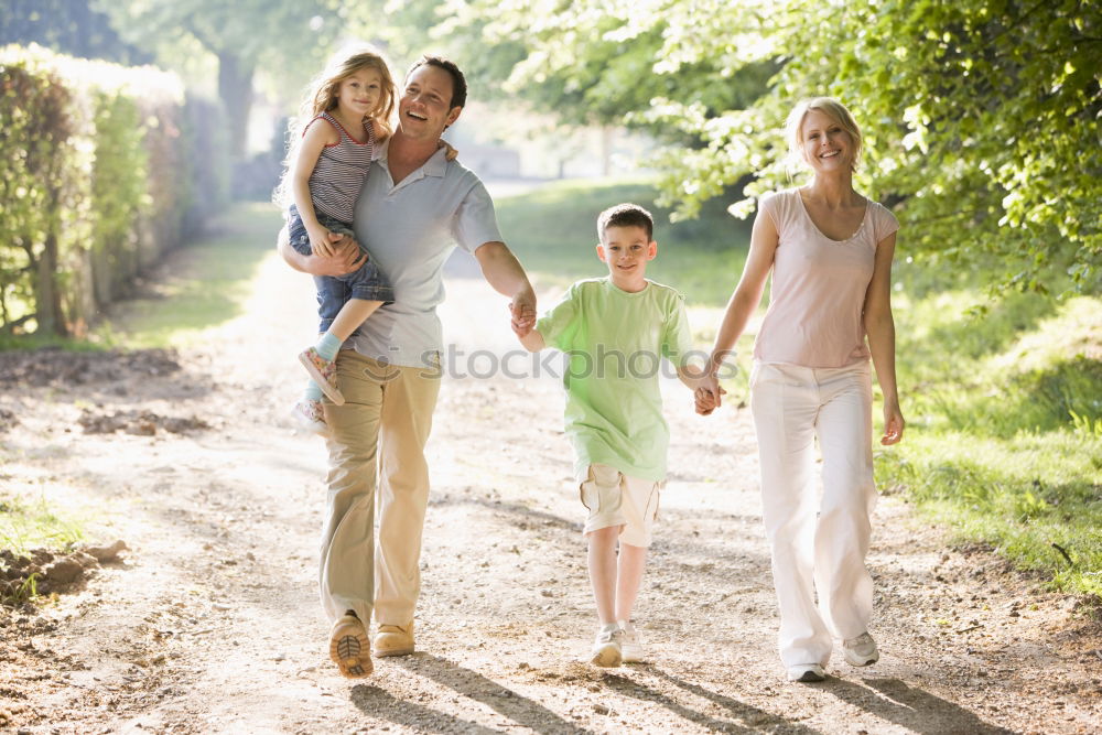 Similar – happy family of four hand in hand on the field