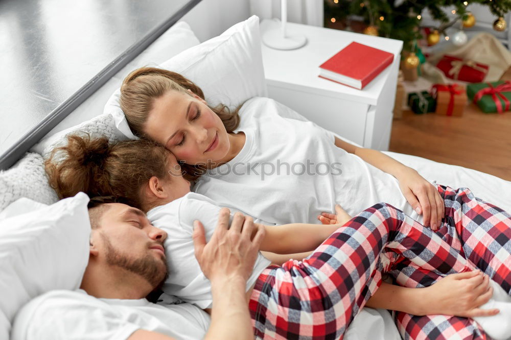 Brother and sister tickling and laughing on bed