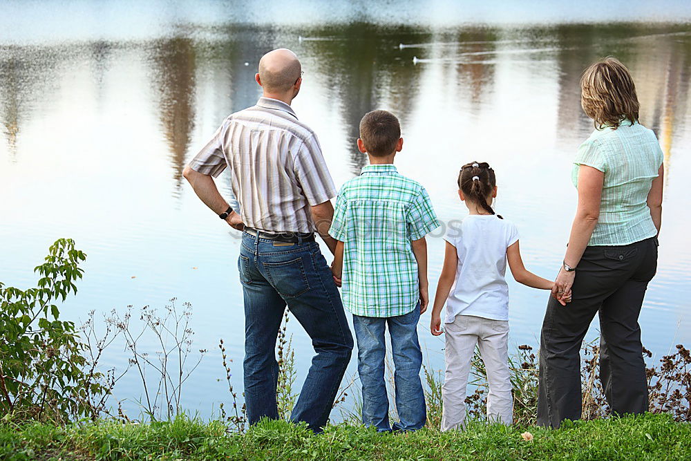 Similar – Grandfather With His grandson on the lake. Back view