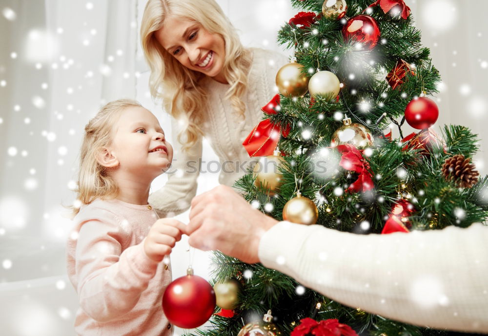 Similar – Young girl and her little sister decorating Christmas tree