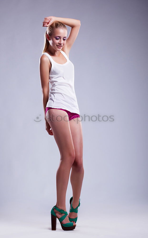 Similar – young, red-haired woman stands barefoot in front of the window and leans against the ceiling beams