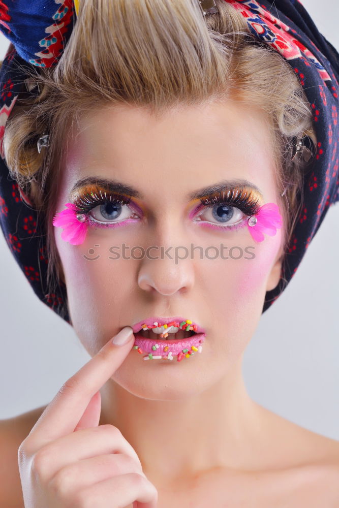 Similar – Young woman with pink hair is holding colorful lollipops