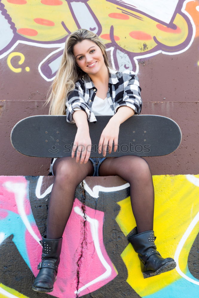 Cool skateboard woman at a public graffiti park