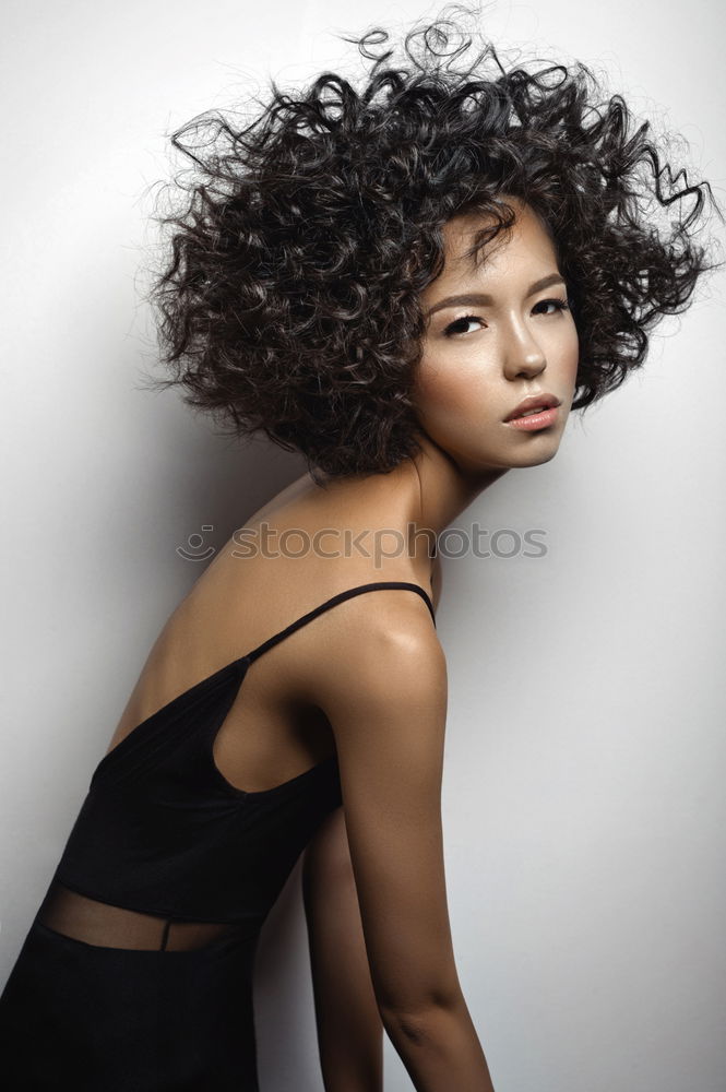 Portrait of attractive afro woman using mobile phone in the street