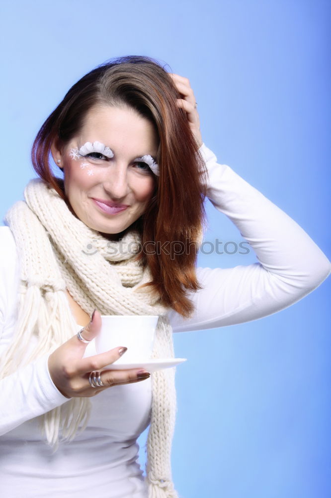 Portrait of a happy beautiful young redhead woman by a colorful wall