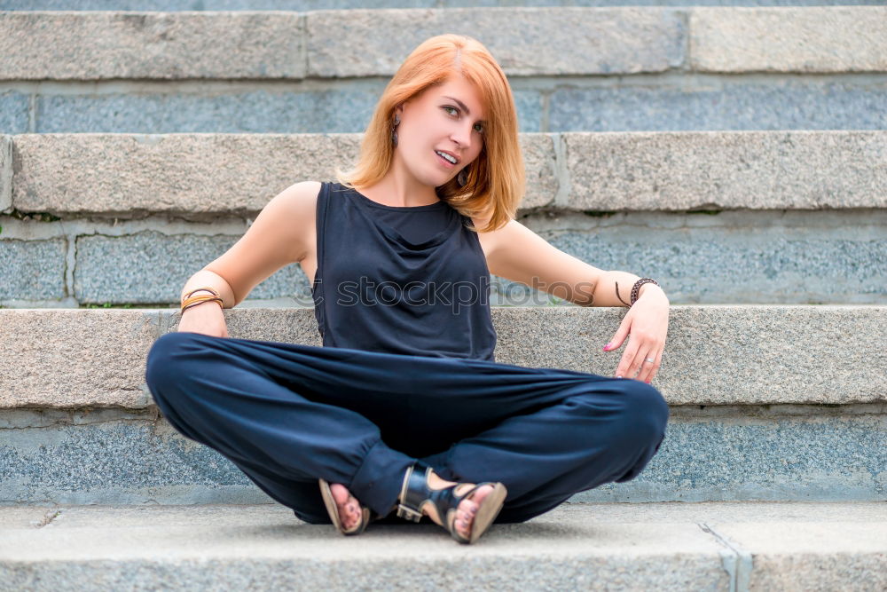 Similar – Young woman sitting leaning against a wall in the shade