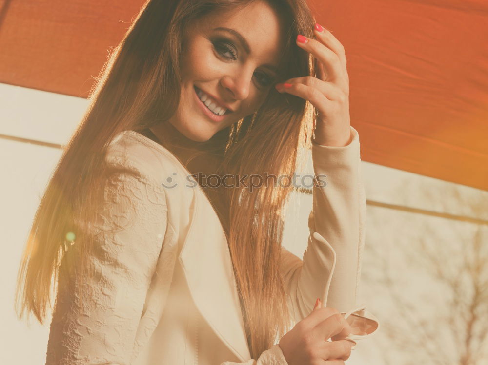 Similar – Beautiful Smiling Woman in red coat with mobile phone in hands, smartphone, urban scene