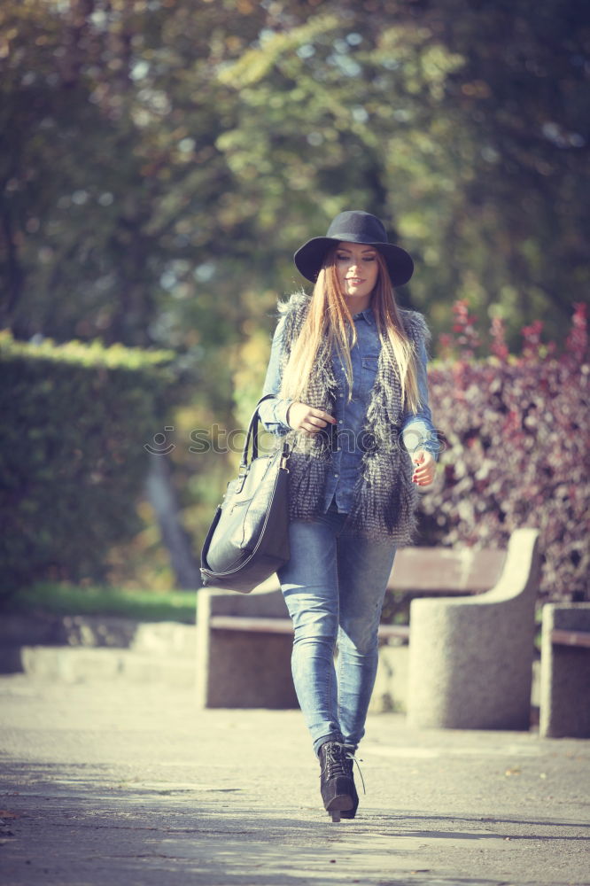 Similar – Young woman with moving hair wearing casual clothes