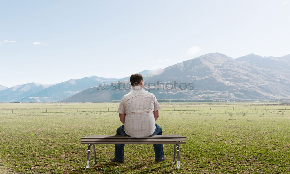 Similar – Couple sitting on a mountain with wide horizon