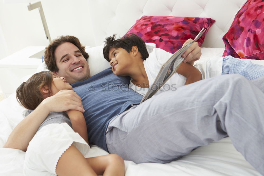 Similar – Brother and sister tickling and laughing on bed